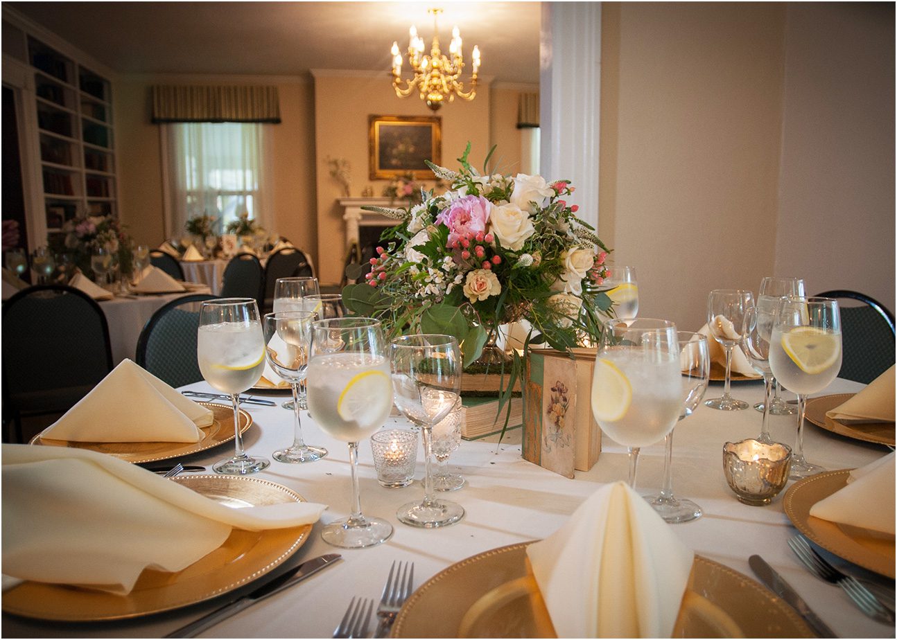 tables set with flowers glasses and candles