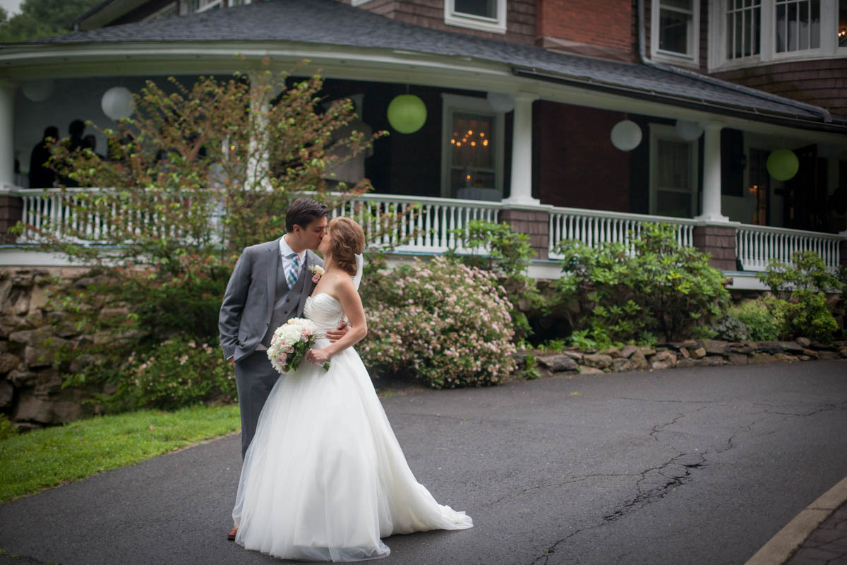 high-school-sweethearts-wed-kissing-in-front-of-mansion