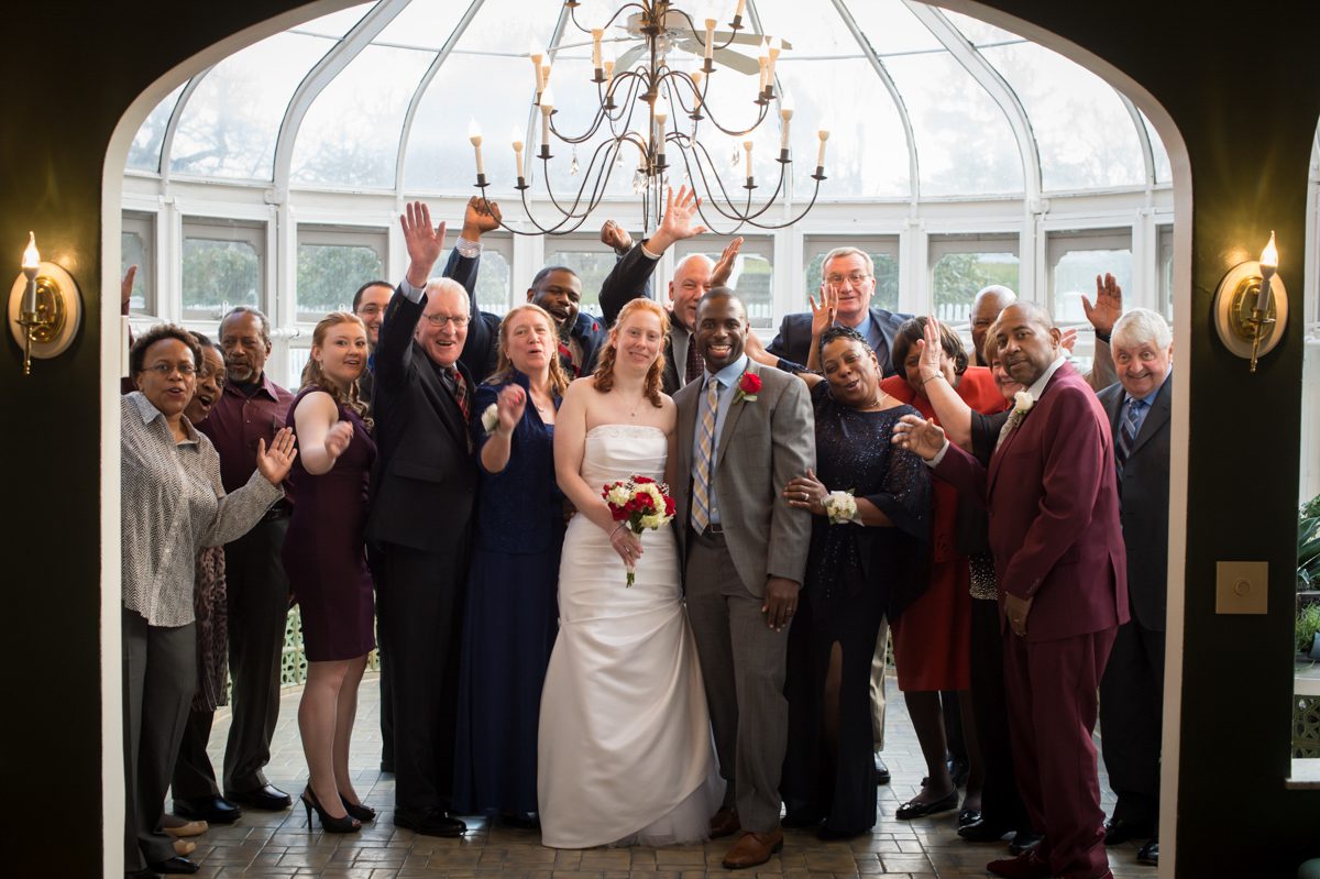 family photo in conservatory with everyone cheering