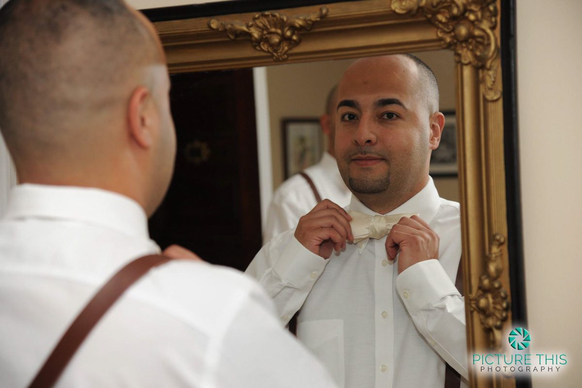 a-victorian-era-wedding-groom-putting-on-bowtie