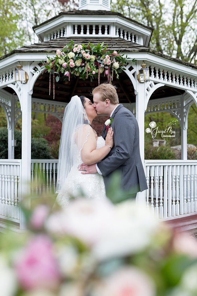 may-wedding-couple-kissing-in-front-of-gazebo