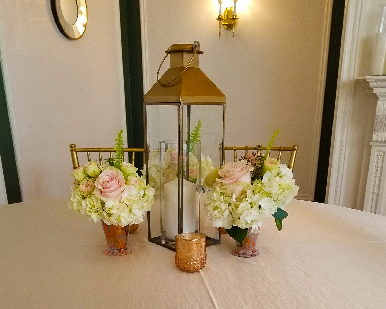 lantern with roses centerpiece on table