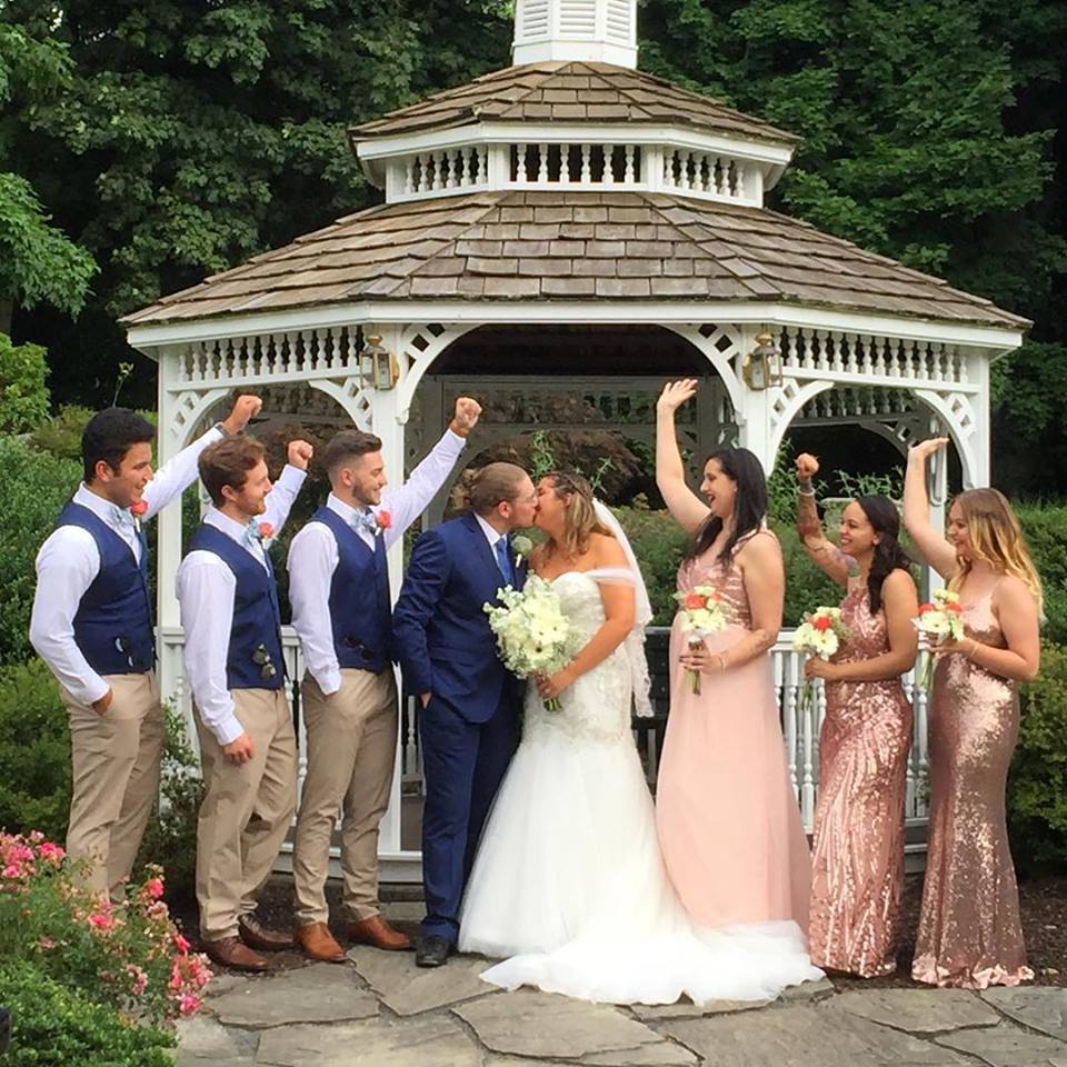 bride and groom with wedding party in front of the gazebo