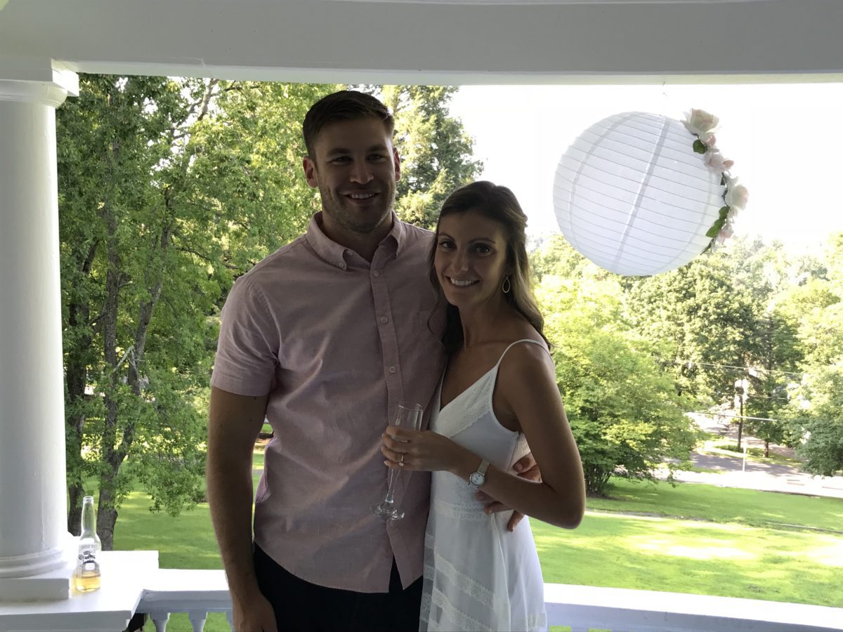 couple standing together on veranda