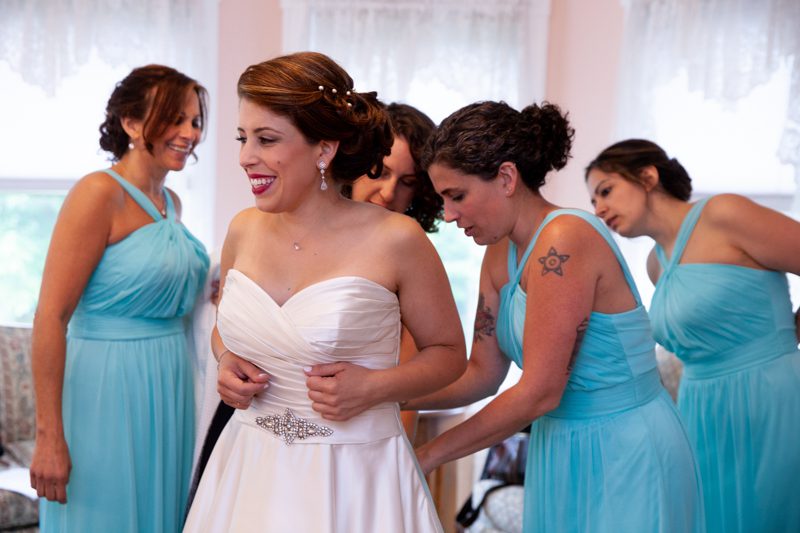 cuban-flair-wedding-Four-bridesmaids-in-aqua-helping-Rachel-into-her-gown