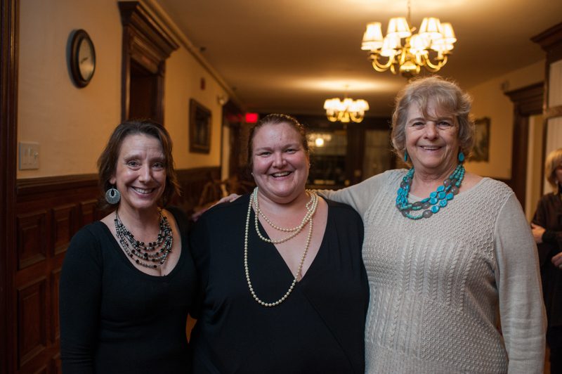 three ladies standing together smiling