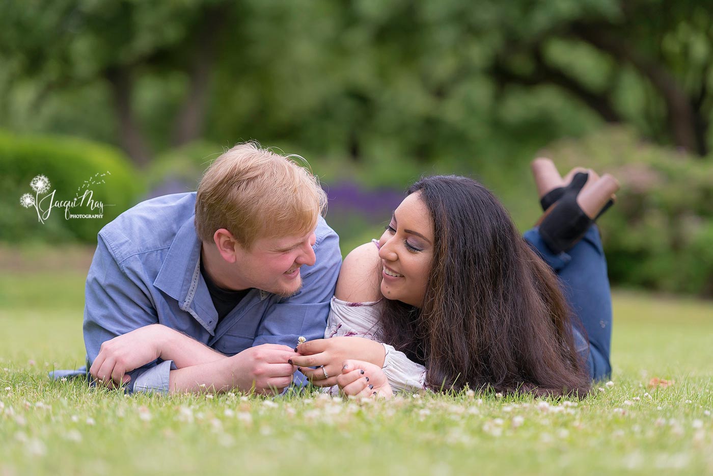 wedding-season-couple-laying-on-grass-smiling-at-each-other