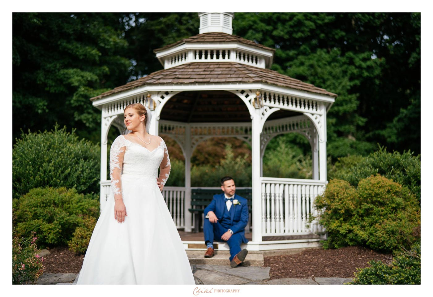 groom sitting on gazebo steps with bride in front