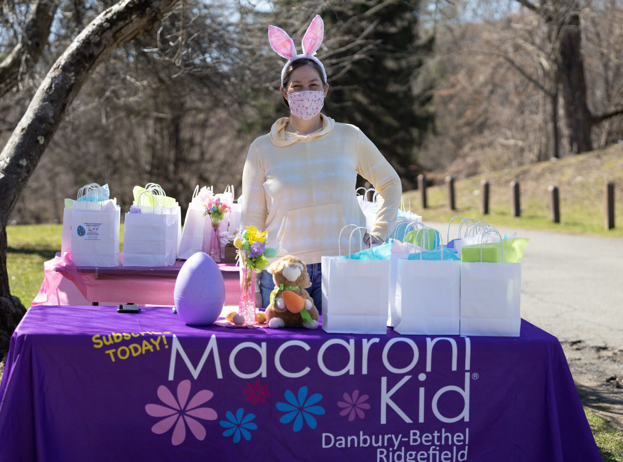 meghan with bunny ears behind table with goodie bags