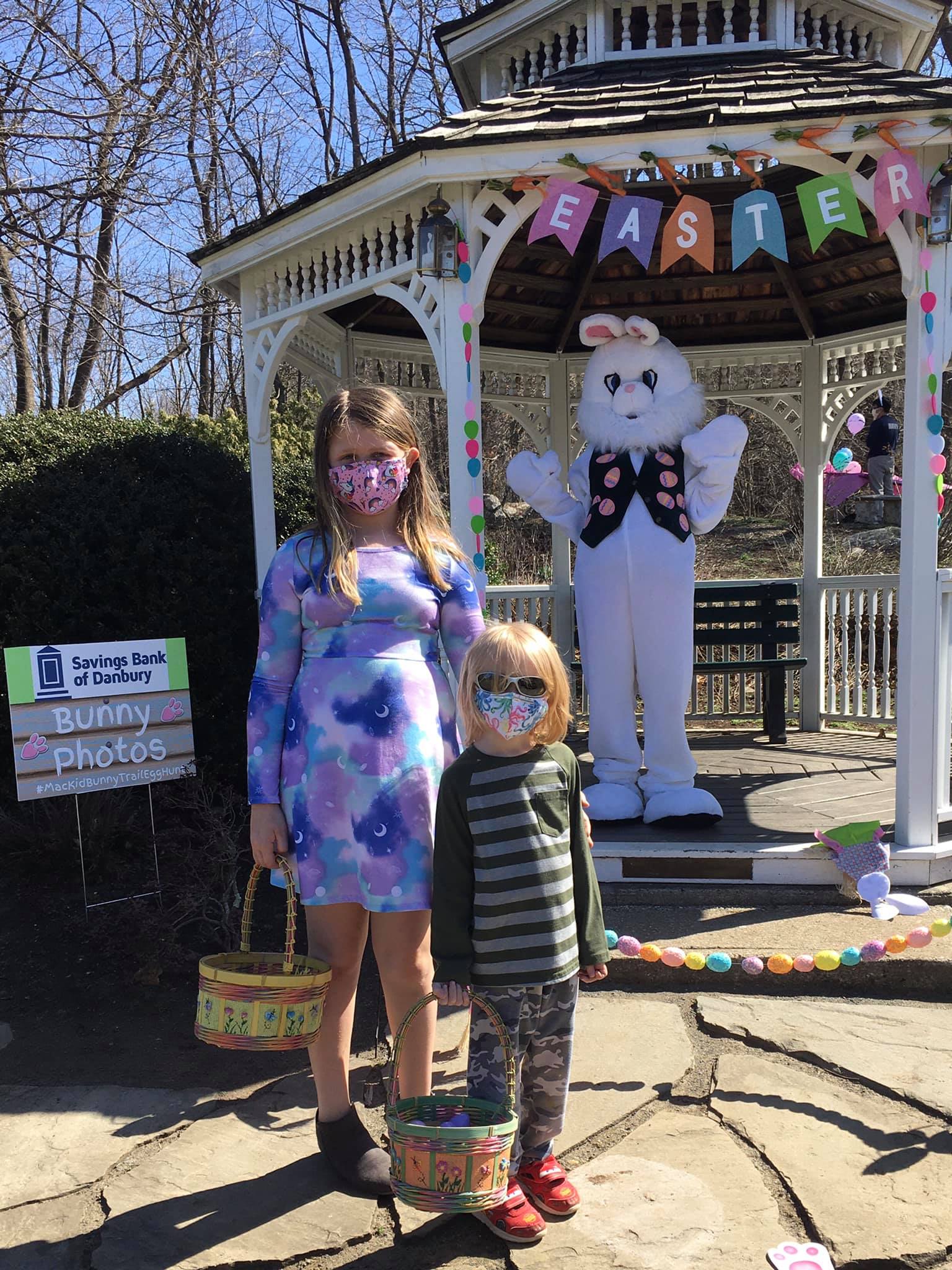 girl and boy standing with easter bunny